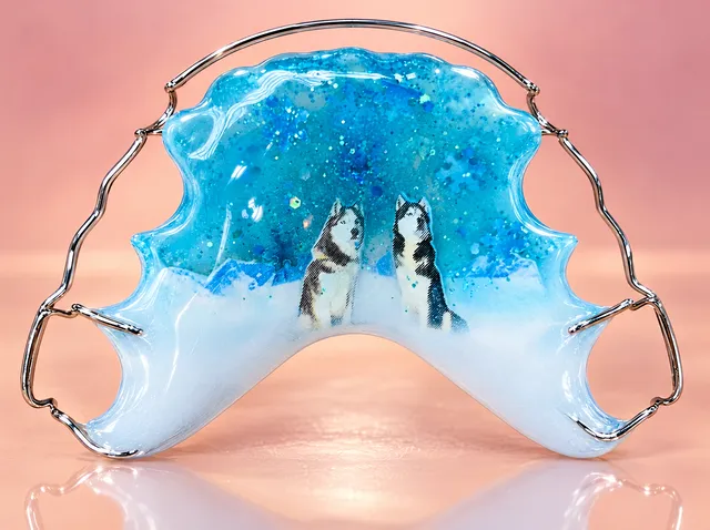 Snow panorama with a turquoise sky, blue snowflakes and huskies